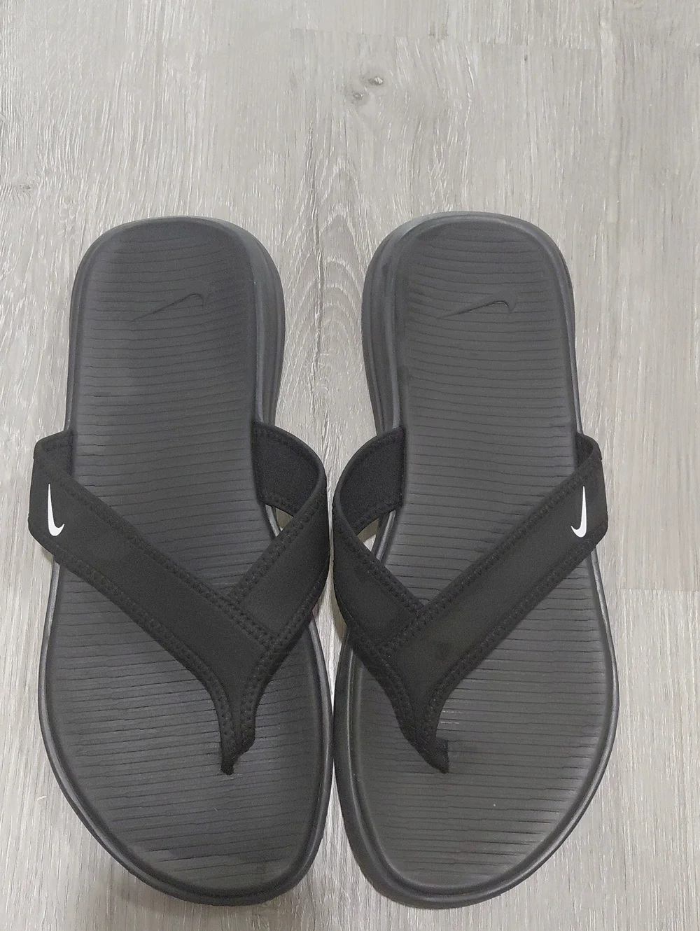 Nike Black Slip-On Sandals with White Swoosh Accent